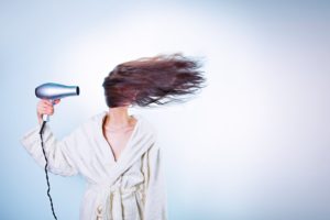 woman blow drying hair with highlights - scizzorhands